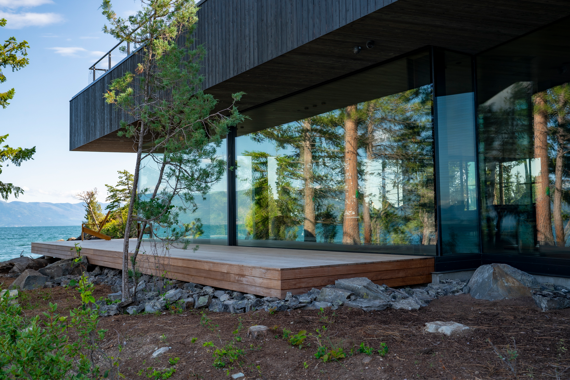 Luxury Montana timber and stone mountain residence illuminated at dusk