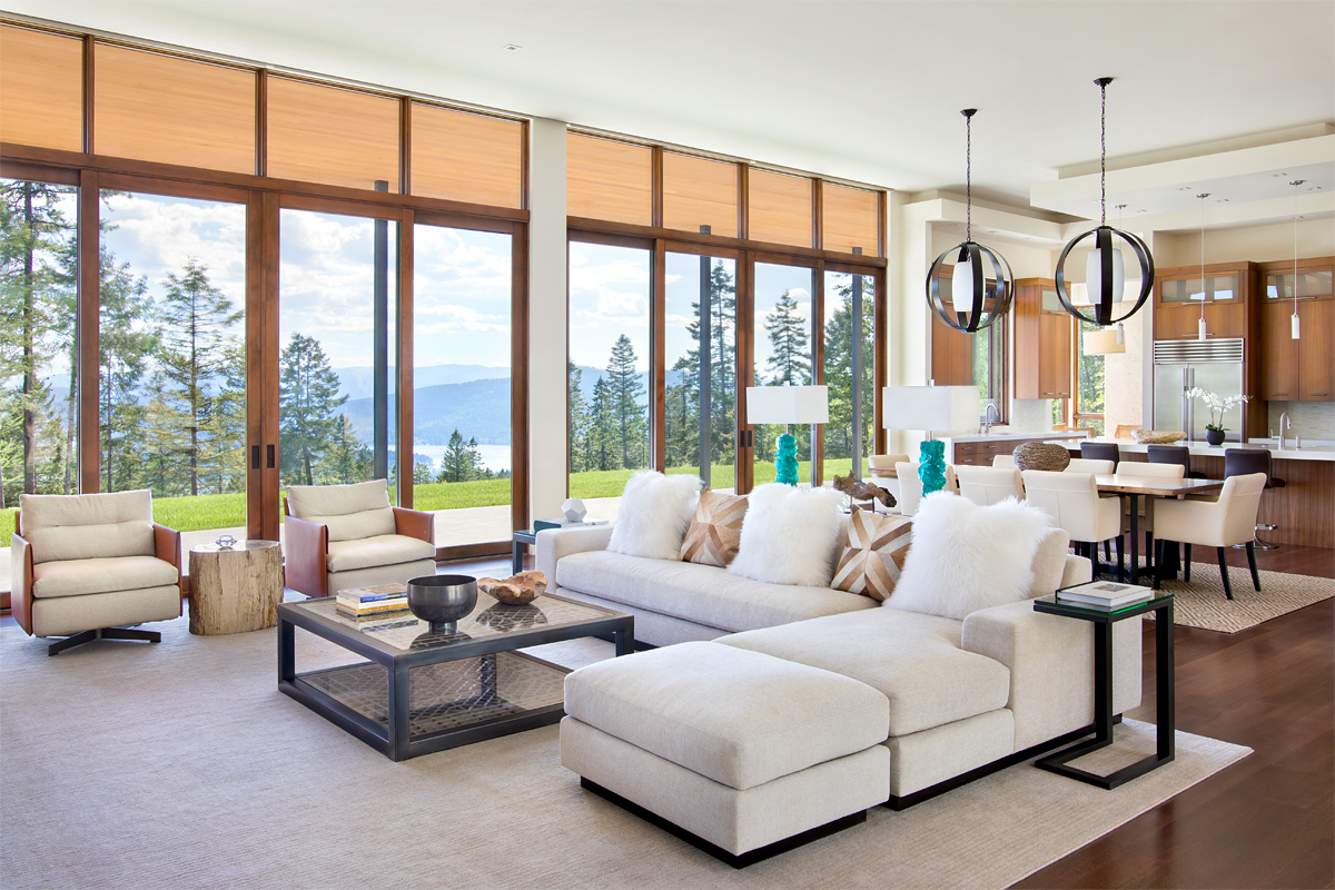 Contemporary architectural custom residence featuring stone masonry and copper detailing at sunset in Montana
