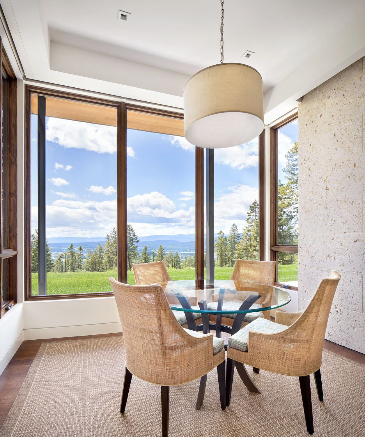 Minimalist floor-to-ceiling glass gallery corridor overlooking mountain landscape