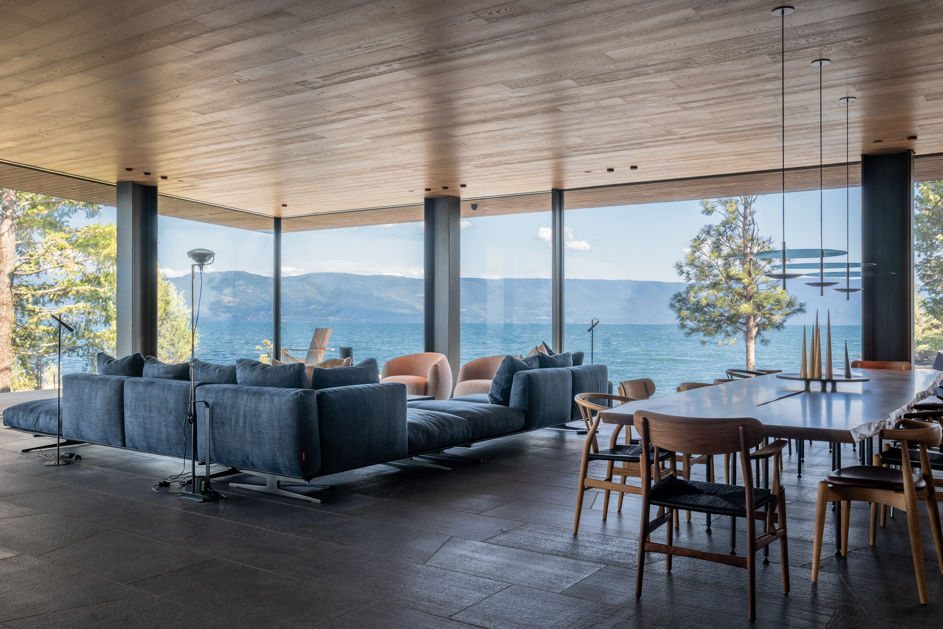 Vaulted great room with hand-hewn Douglas fir beams and double-sided dry stack fireplace